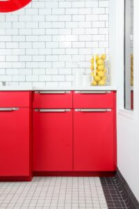 Red Cabinetry With Stainless Steel Hardware